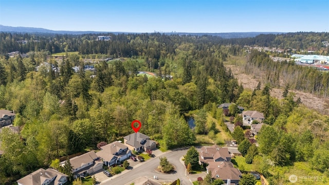 birds eye view of property featuring a view of trees and a residential view