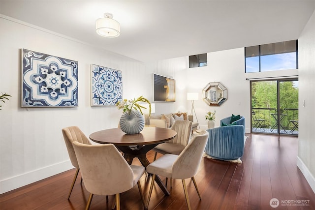 dining space featuring dark wood-style floors and baseboards