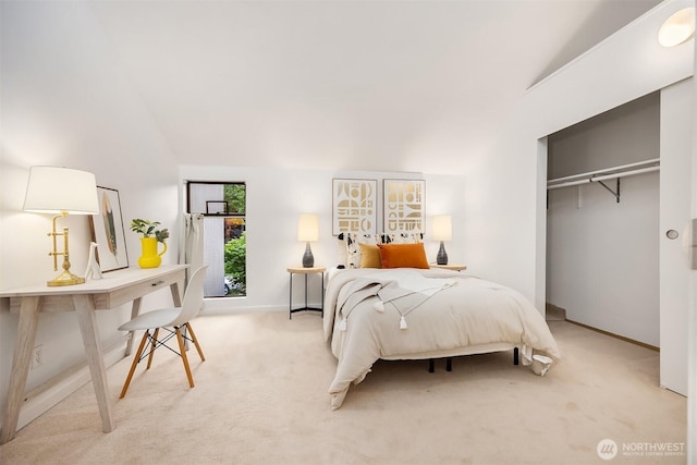 bedroom featuring lofted ceiling, light carpet, baseboards, and a closet