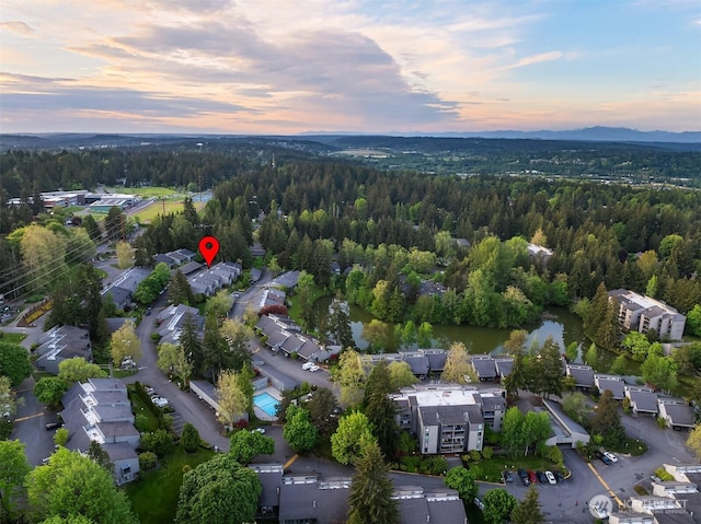 aerial view of property's location with a heavily wooded area