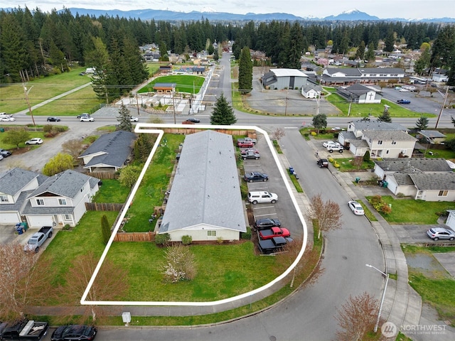 bird's eye view with a residential view, a mountain view, and a wooded view