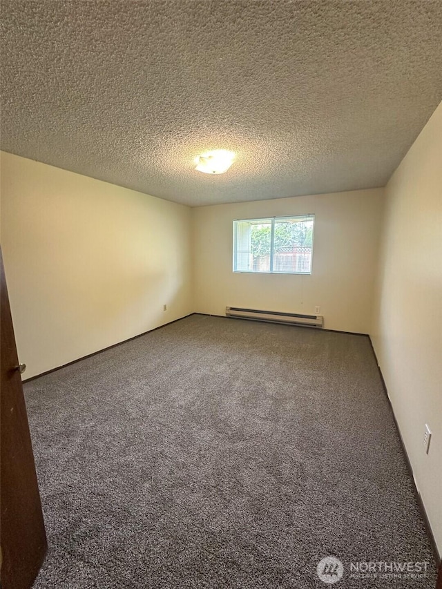 carpeted empty room featuring a textured ceiling and baseboard heating