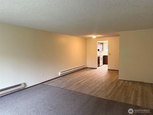unfurnished room with light wood-style floors, a textured ceiling, and a baseboard radiator