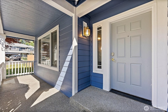 view of exterior entry featuring a porch