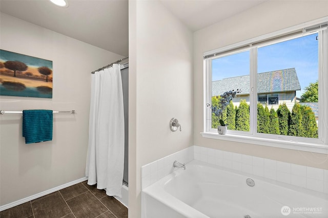 bathroom featuring a shower with curtain, baseboards, and a garden tub