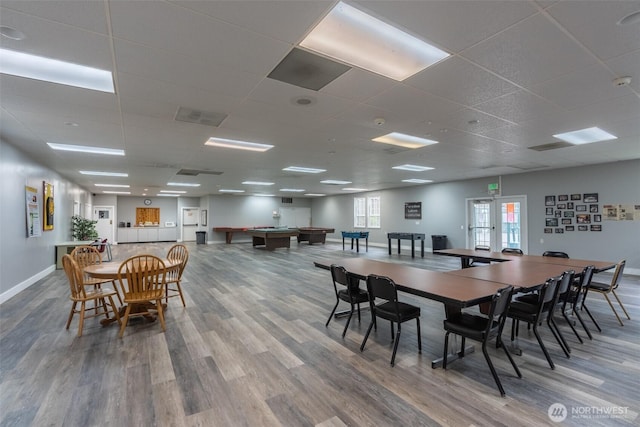 dining area featuring billiards, baseboards, wood finished floors, and a paneled ceiling
