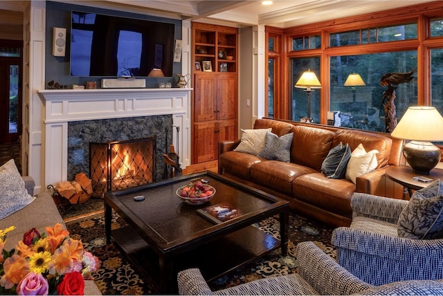 living room with a fireplace and ornamental molding