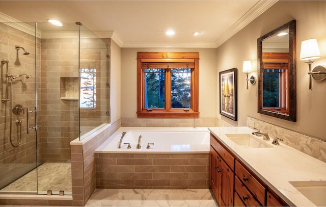 bathroom with a shower stall, crown molding, a bath, and a sink