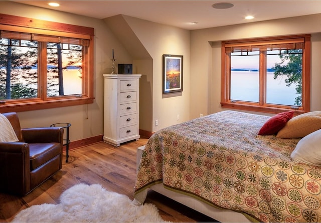 bedroom featuring wood finished floors, recessed lighting, and baseboards