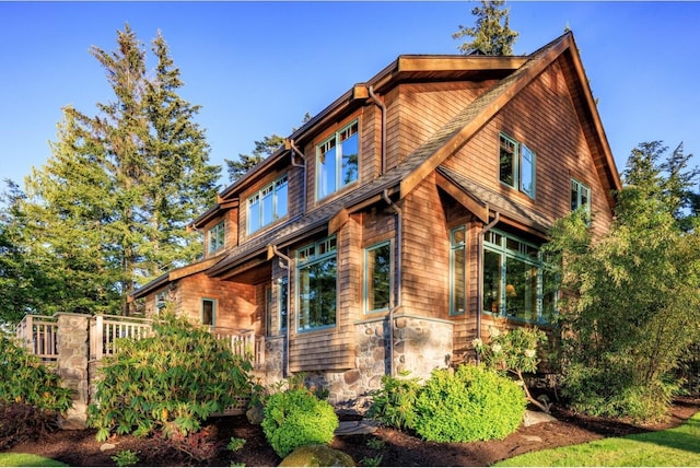 view of side of home with stone siding