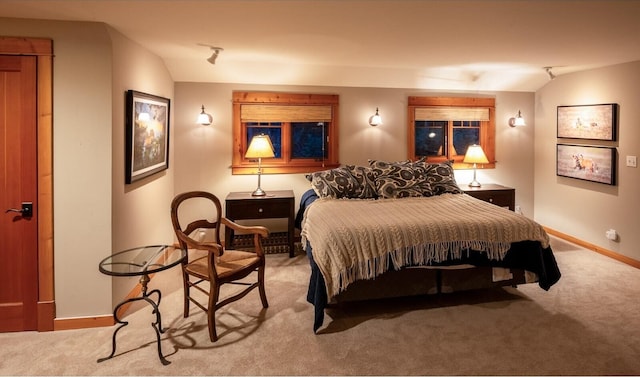 bedroom with carpet, vaulted ceiling, and baseboards
