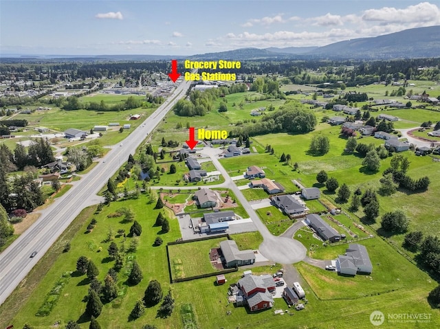 drone / aerial view featuring a residential view and a mountain view