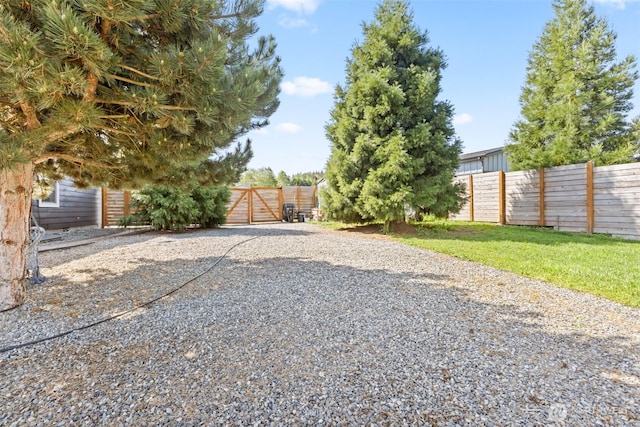 view of yard with fence and a gate