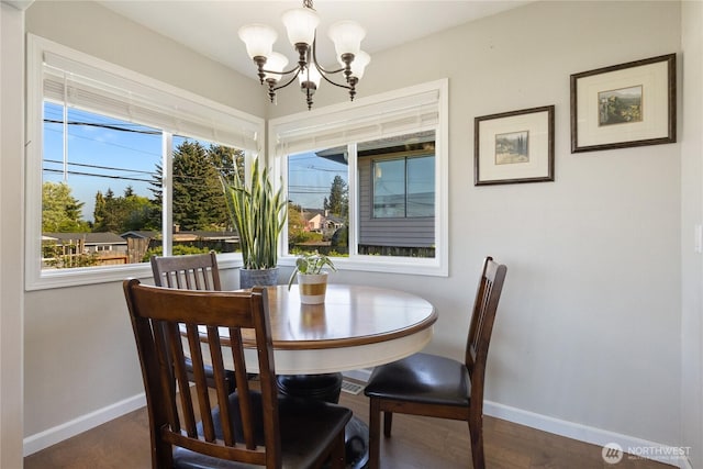 dining space featuring an inviting chandelier and baseboards
