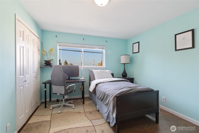 bedroom with baseboards and a closet