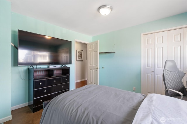 bedroom with baseboards, a closet, and wood finished floors