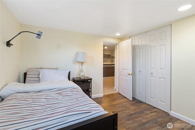 bedroom with recessed lighting, baseboards, wood finished floors, and a closet