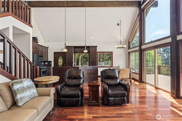 living area with a notable chandelier, high vaulted ceiling, and beamed ceiling