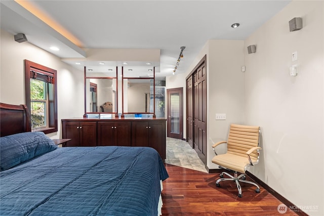 bedroom with recessed lighting and wood finished floors