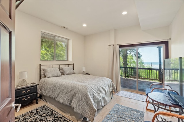 bedroom featuring light tile patterned floors, access to outside, multiple windows, and visible vents