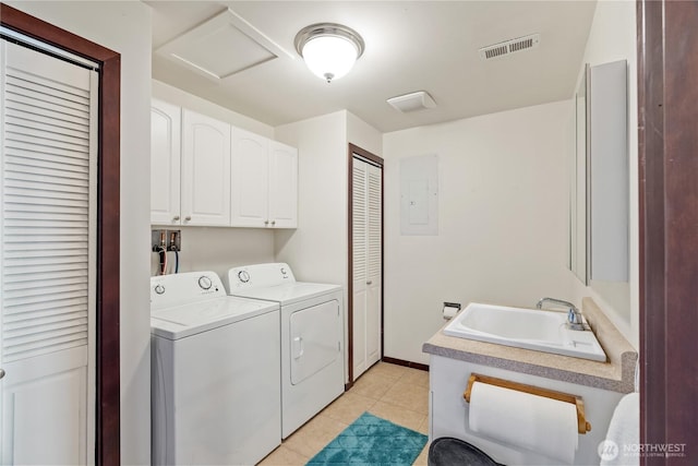 laundry area featuring visible vents, washing machine and dryer, attic access, a sink, and cabinet space