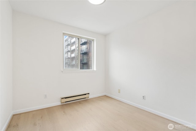 769 Hayes St Unit 405, Seattle, WA 98109 - empty room with a baseboard heating unit and wood finished floors