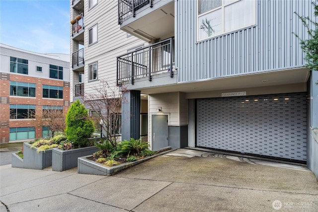 769 Hayes St Unit 405, Seattle, WA 98109 - view of building exterior with a garage