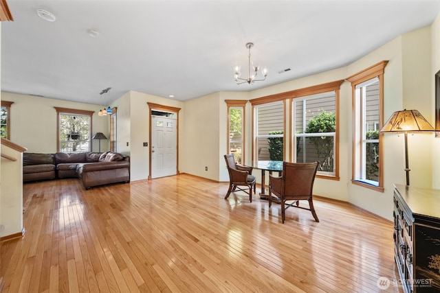 7827 Ingram Ln SE, Snoqualmie, WA 98065 - dining area featuring light wood-style floors, a notable chandelier, and visible vents