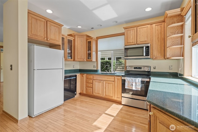 7827 Ingram Ln SE, Snoqualmie, WA 98065 - kitchen with appliances with stainless steel finishes, a sink, light wood-style floors, recessed lighting, and glass insert cabinets