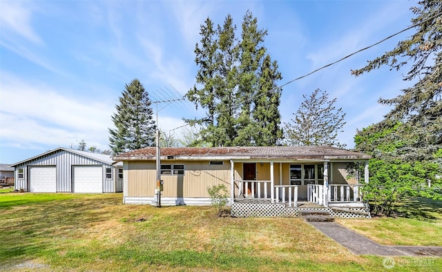 single story home featuring a porch, a garage, a front yard, and an outdoor structure