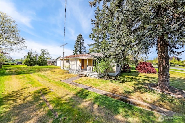 bungalow-style home featuring covered porch and a front yard