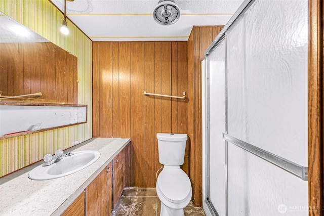 bathroom with tile patterned flooring, a textured ceiling, a shower with door, and toilet