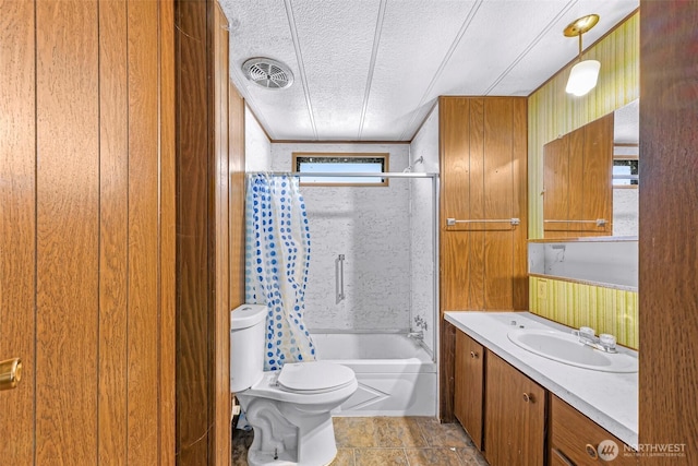 full bath with shower / tub combo with curtain, vanity, toilet, a textured ceiling, and visible vents