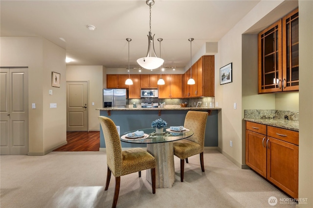 150 102nd Ave SE Unit 213, Bellevue, WA 98004 - dining room featuring baseboards and light carpet