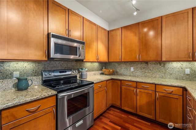 150 102nd Ave SE Unit 213, Bellevue, WA 98004 - kitchen with dark wood-type flooring, brown cabinets, and stainless steel appliances