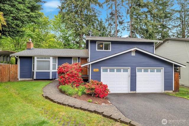 split level home with a garage, a front lawn, fence, a chimney, and driveway