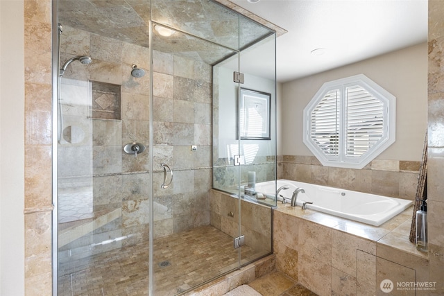 full bathroom with a bath and a stall shower