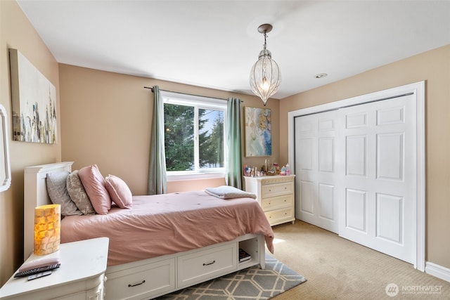 bedroom featuring a closet and light carpet