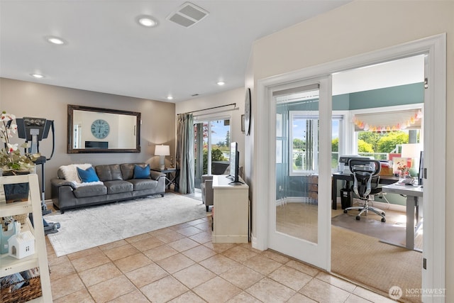 living room with visible vents, recessed lighting, light tile patterned flooring, and french doors