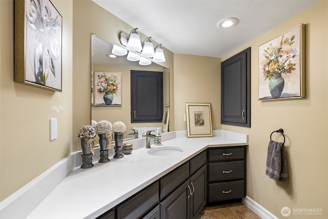 bathroom featuring vanity, tile patterned flooring, baseboards, and recessed lighting
