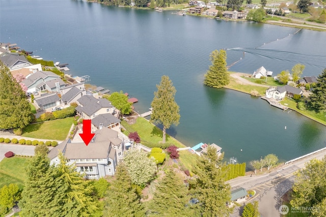 drone / aerial view featuring a water view and a residential view