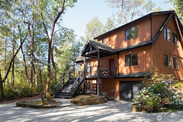 view of front of house featuring driveway, stairway, and a garage