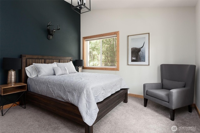 bedroom featuring baseboards and carpet