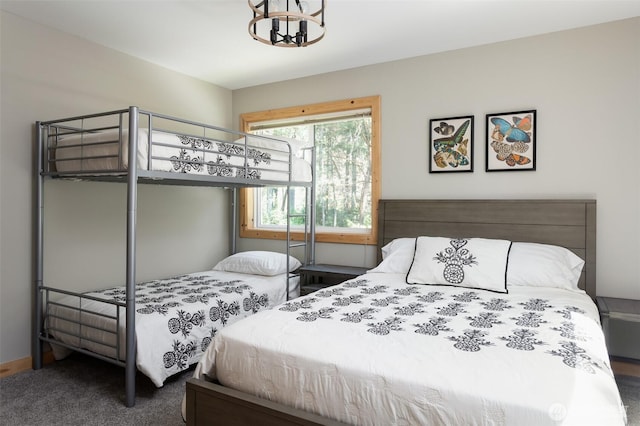 carpeted bedroom with an inviting chandelier