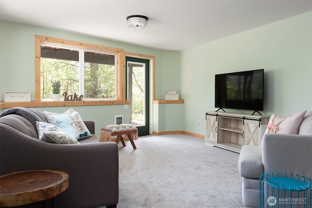 living room featuring carpet and baseboards