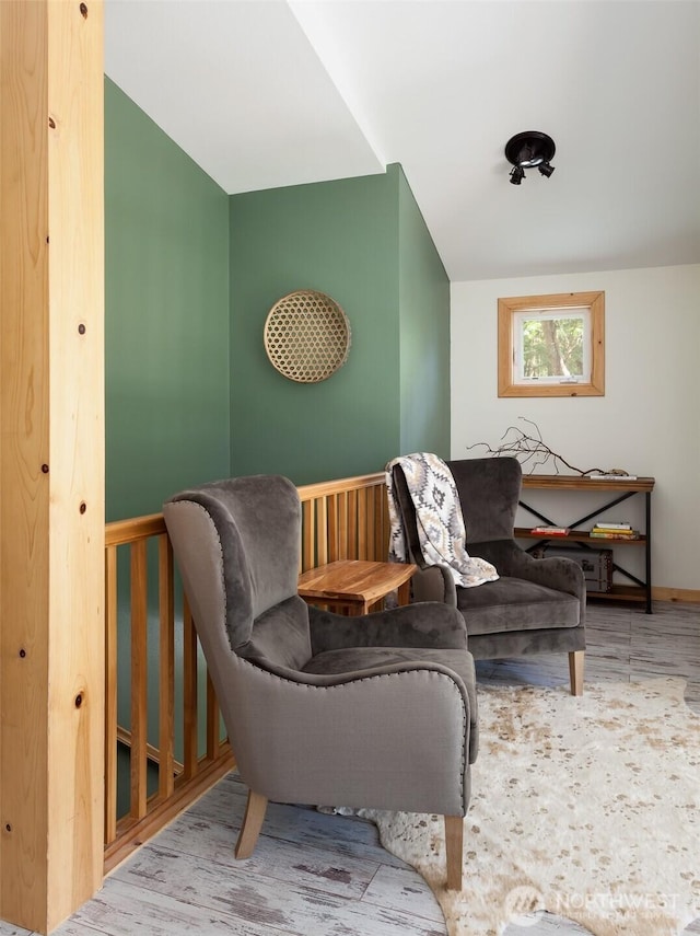 living area with wood finished floors and baseboards