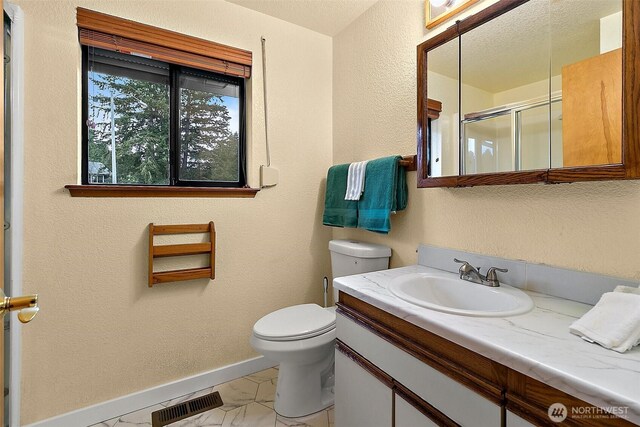 bathroom with toilet, marble finish floor, baseboards, visible vents, and a stall shower