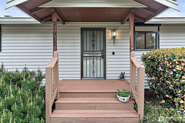 view of exterior entry with a porch