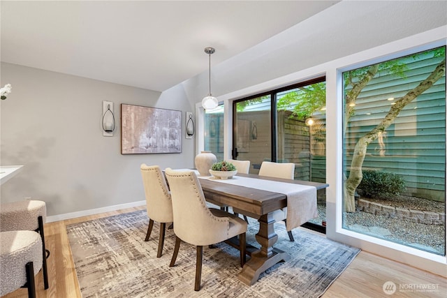 dining room with baseboards and light wood-type flooring