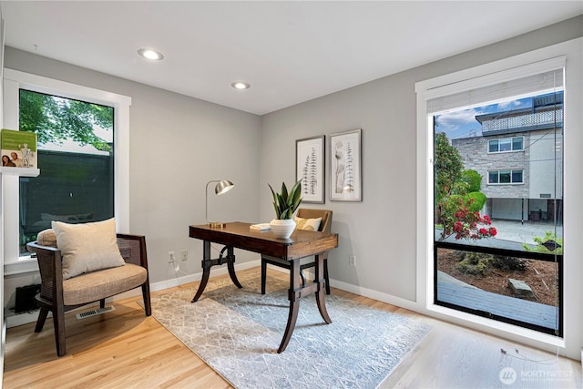 office featuring recessed lighting, baseboards, visible vents, and light wood finished floors